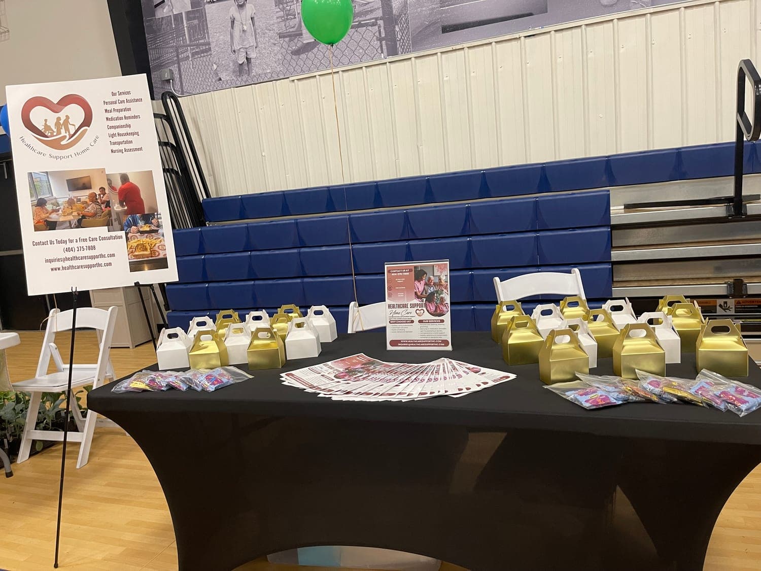 The Healthcare Support Home Care table at the 2025 Douglas County Senior Services Health and Wellness Festival, laid out with gift boxes and flyers