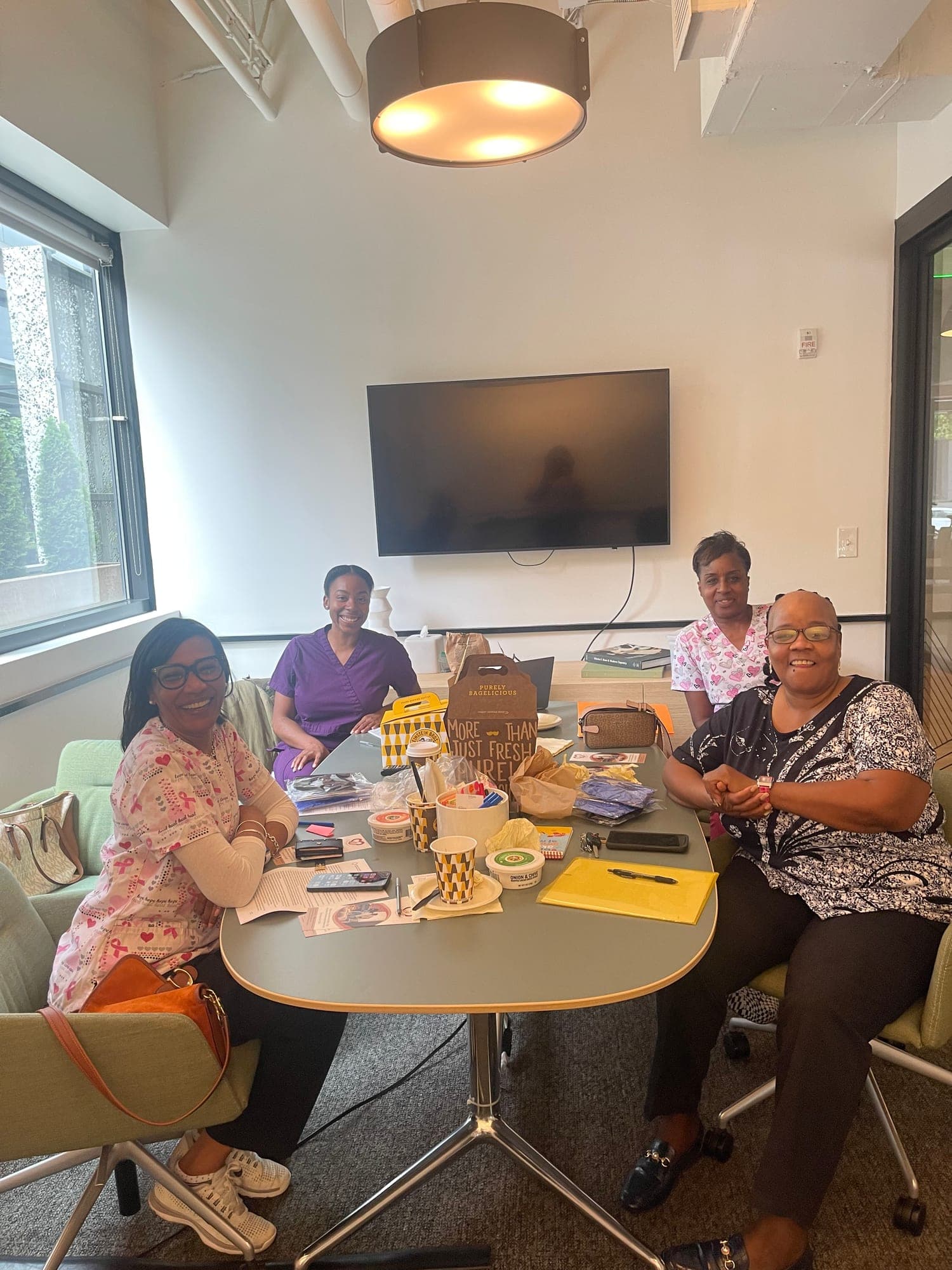 The Healthcare Support Home Care team gathered around a table at a staff meeting