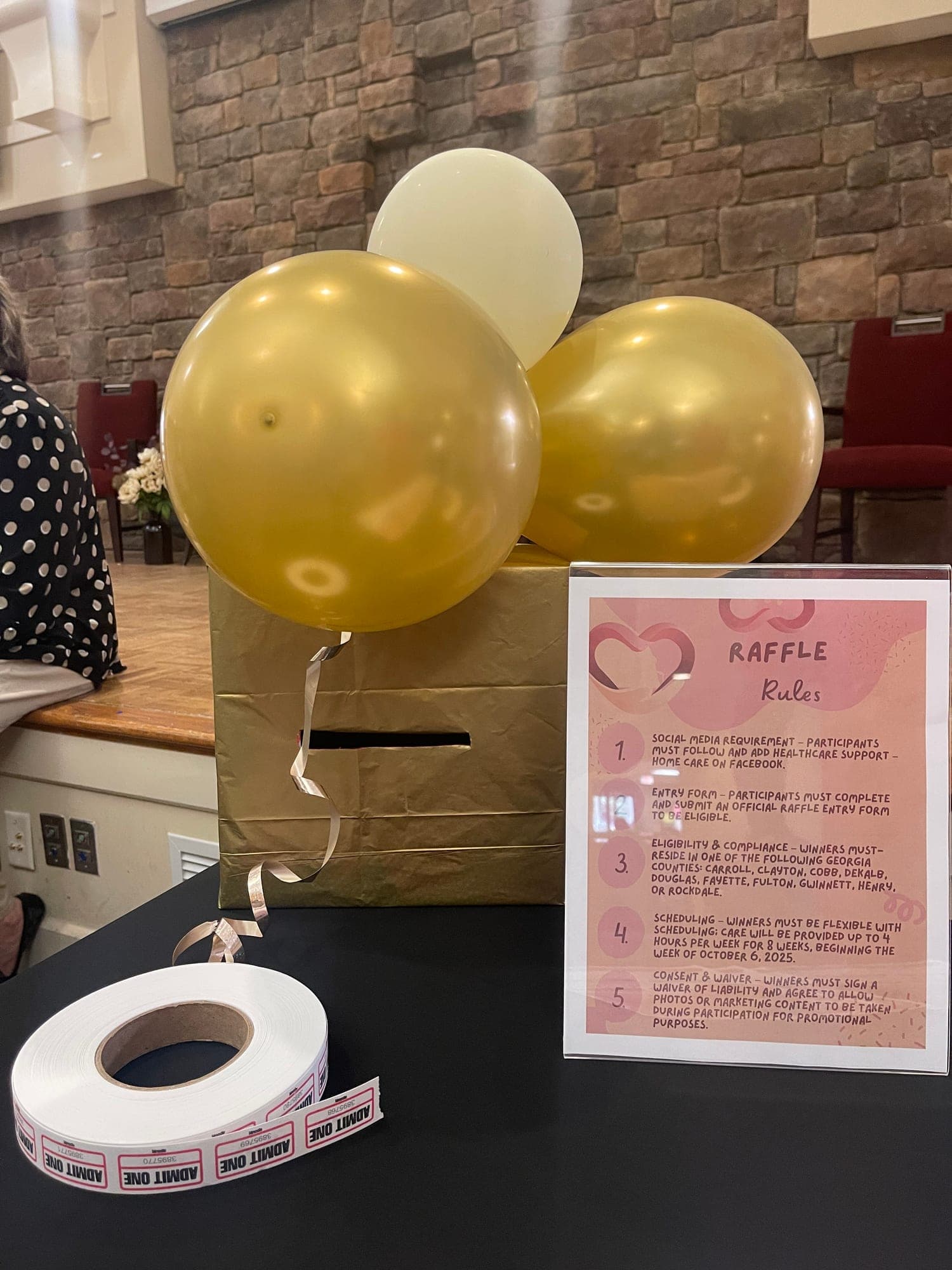 The agency's raffle box and gold balloons at the Pruitt Christian City Community Resource Event
